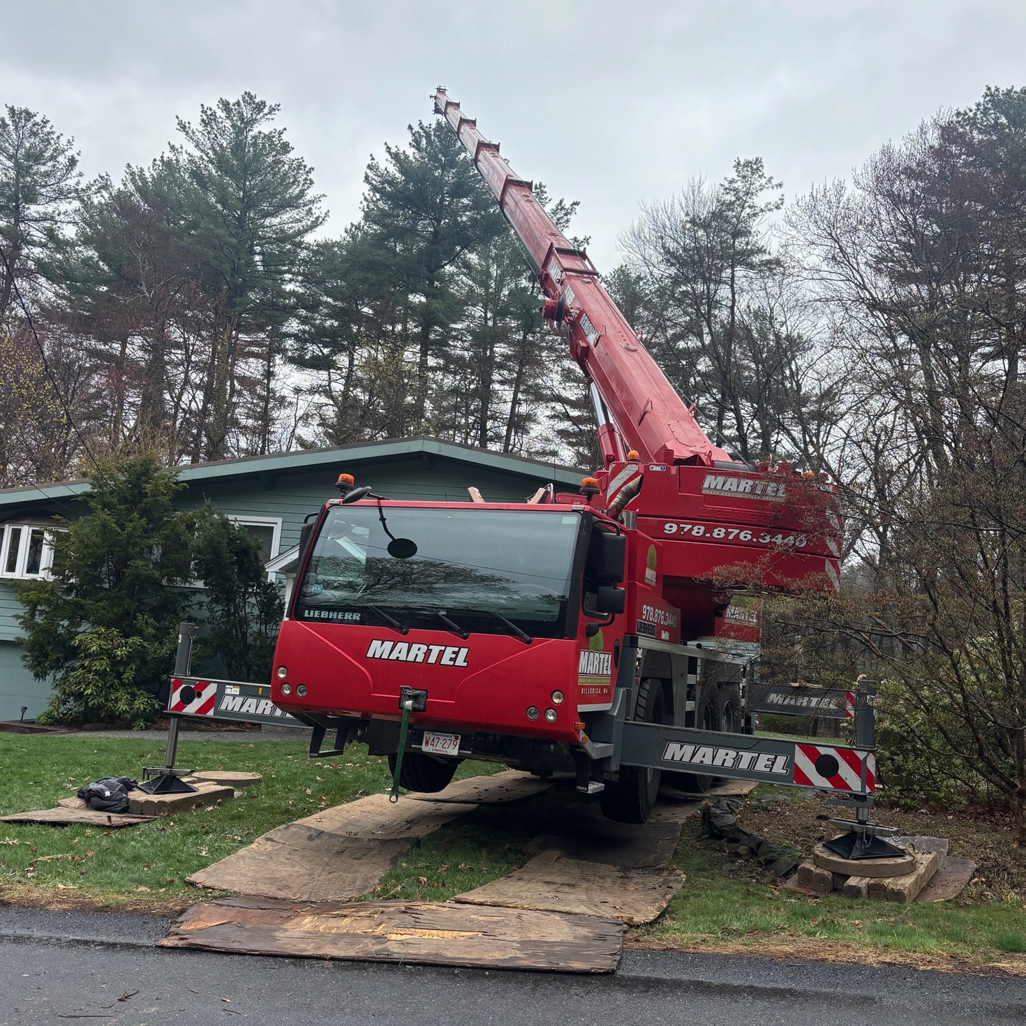 Martel Crane Service & Tree Removal set up in the front yard of this Burlington residence to safely remove large trees.