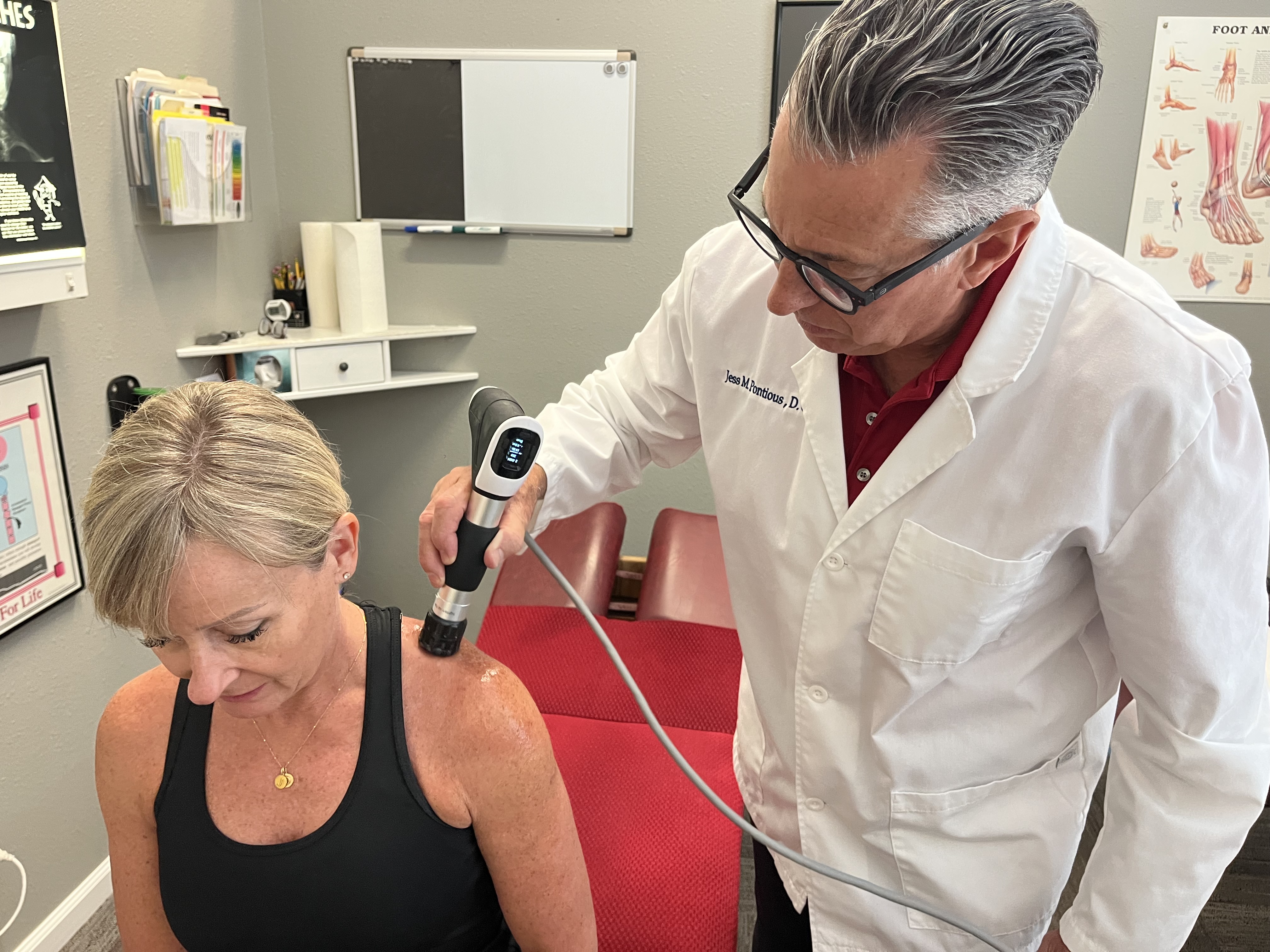 Dr. Pontious performing shockwave therapy on a patient