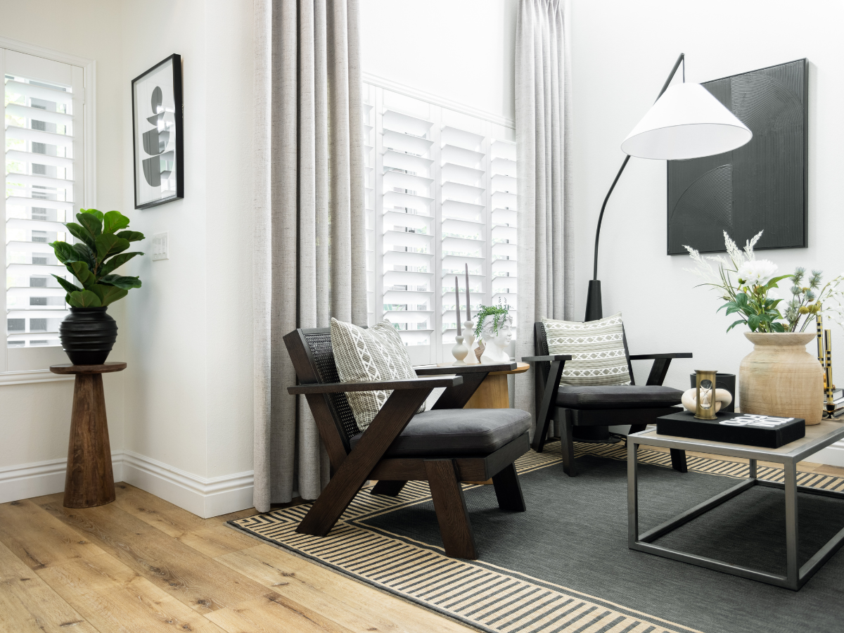Living room featuring Norman wood shutters and Vadain drapery panels.