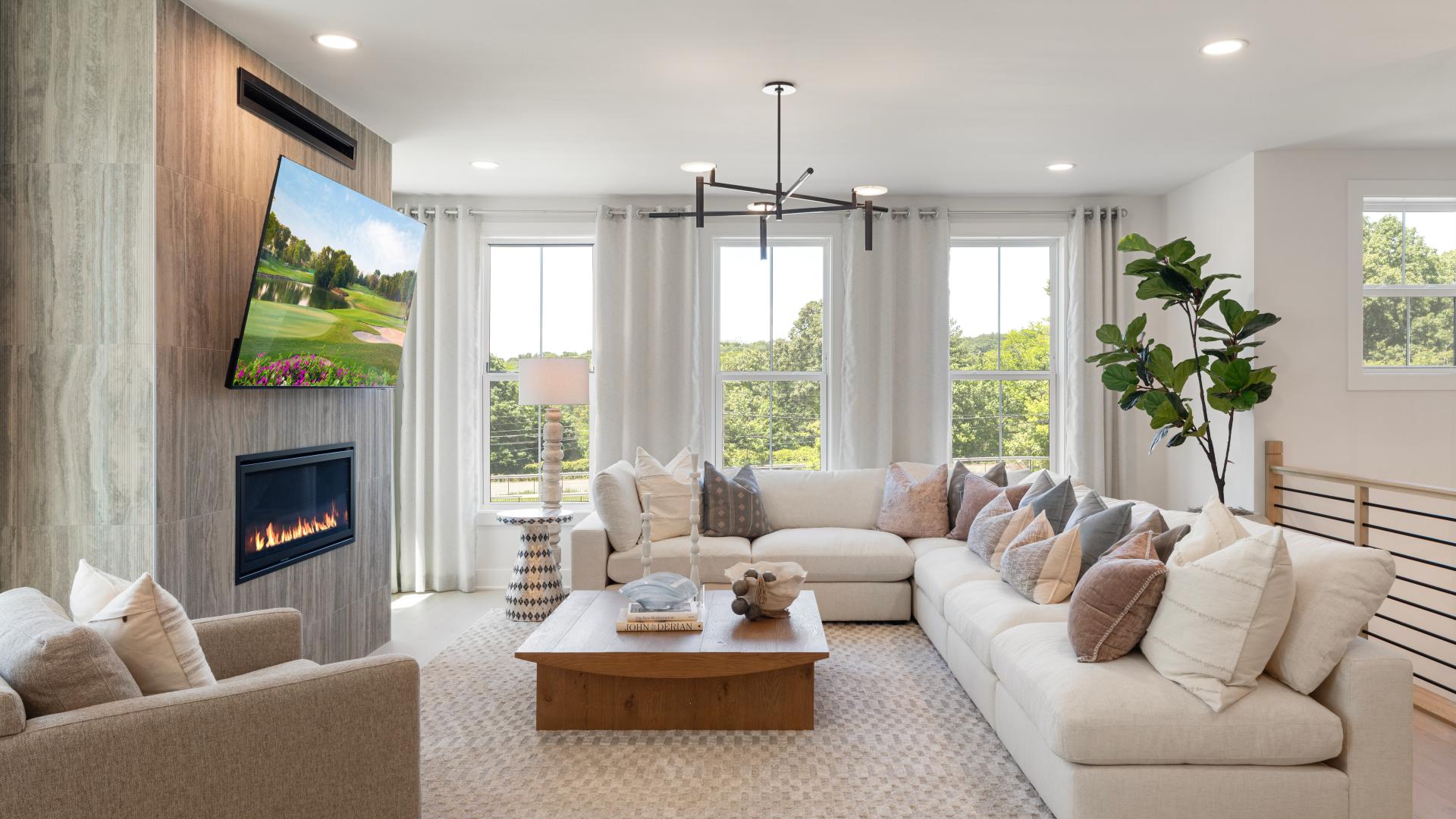 Great room features tall windows and gas fireplace