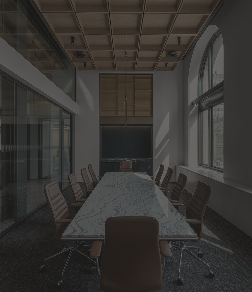 Sleek boardroom with large windows and a long marble conference table surrounded by brown leather chairs.
