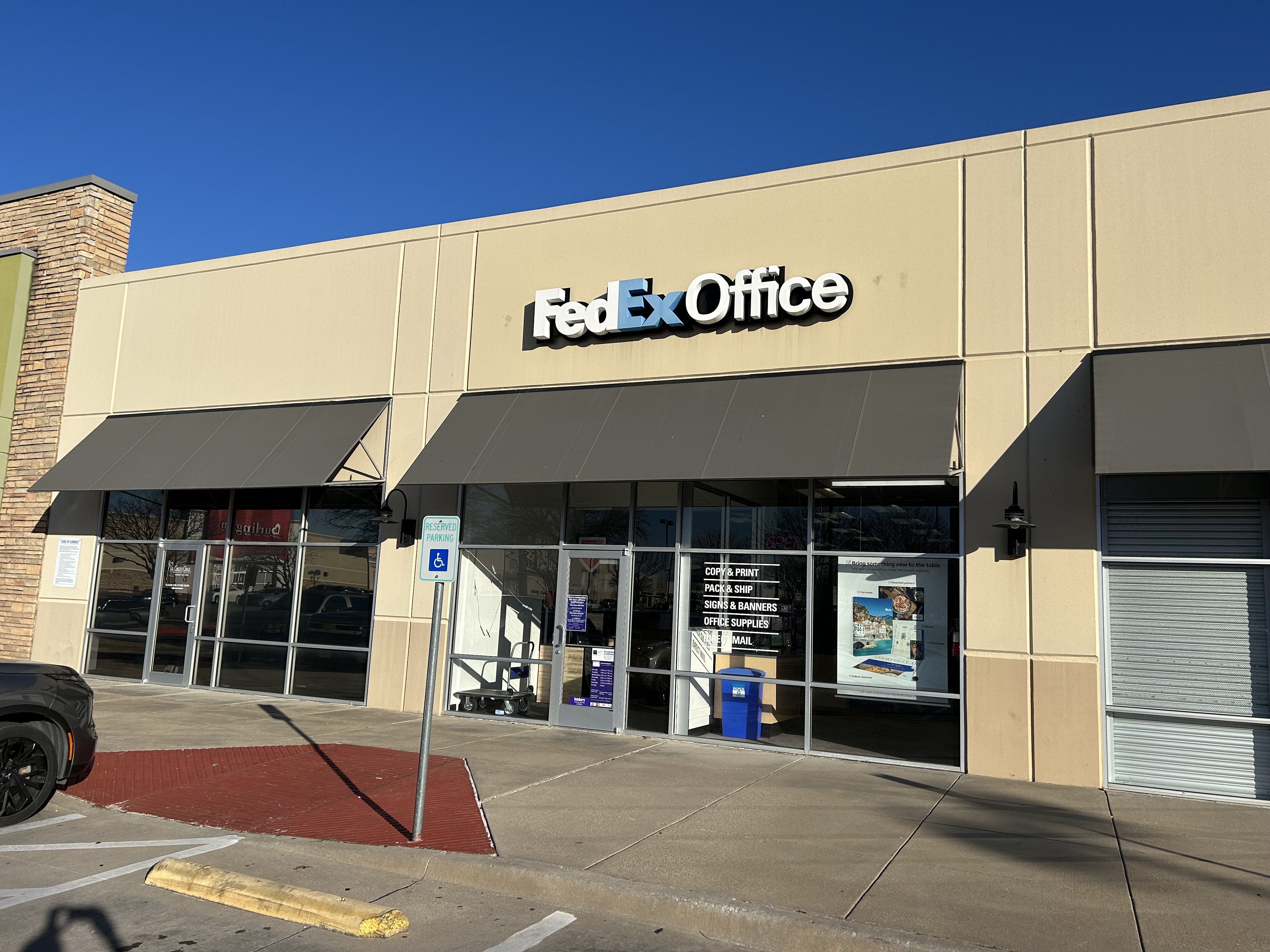 Storefront Exterior &ndash; FedEx Office Print and Ship Center storefront in Burleson Texas with exterior signage and customer entrance.