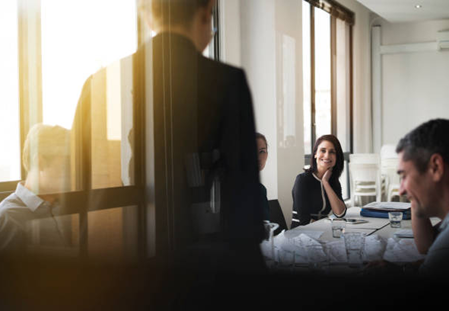A group of financial advisors sitting around a desk during a meeting.