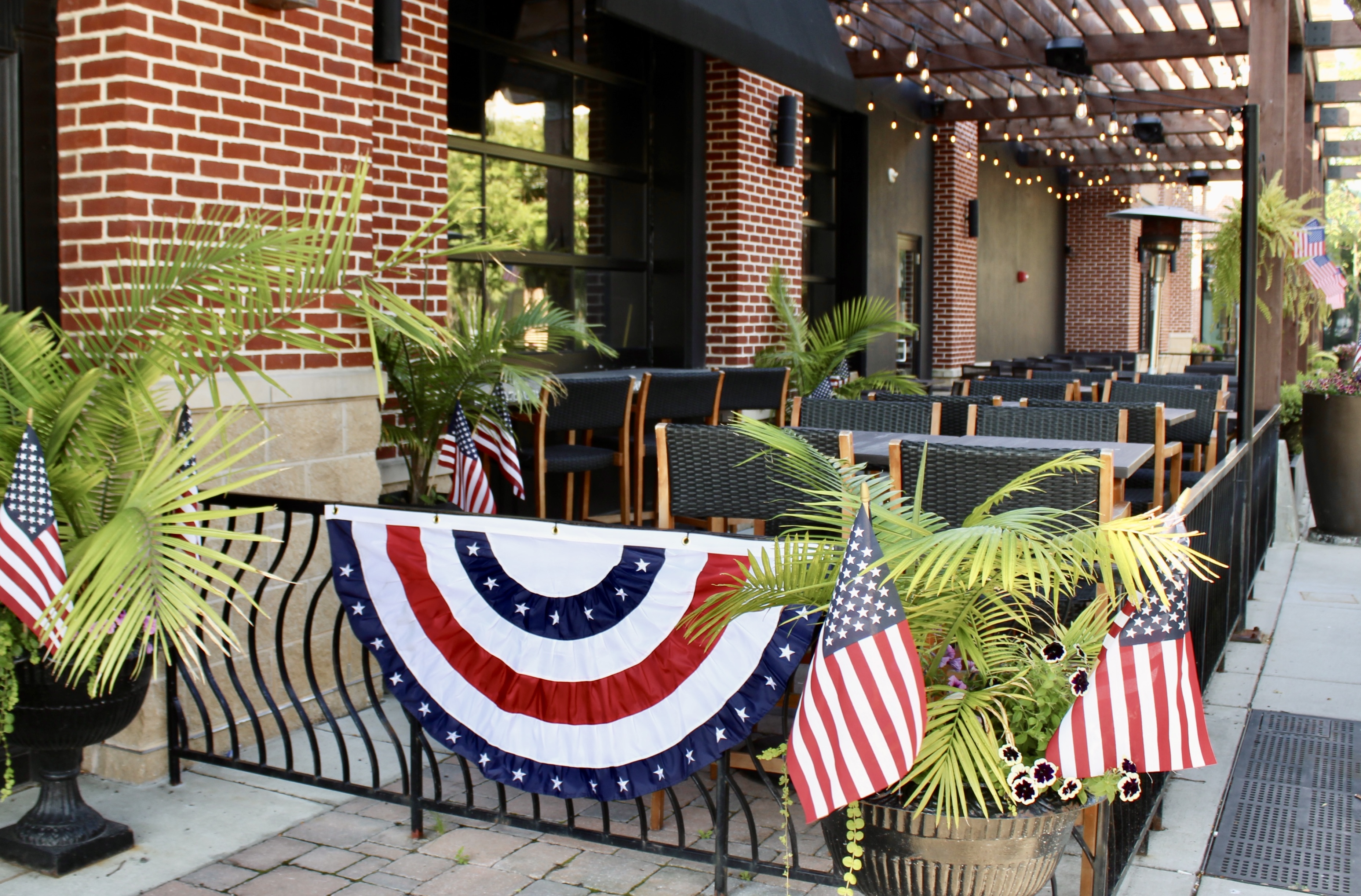 Mama's On The Half Shell Owings Mills Outdoor Dining Area dressed in American flags for Fourth of Ju 