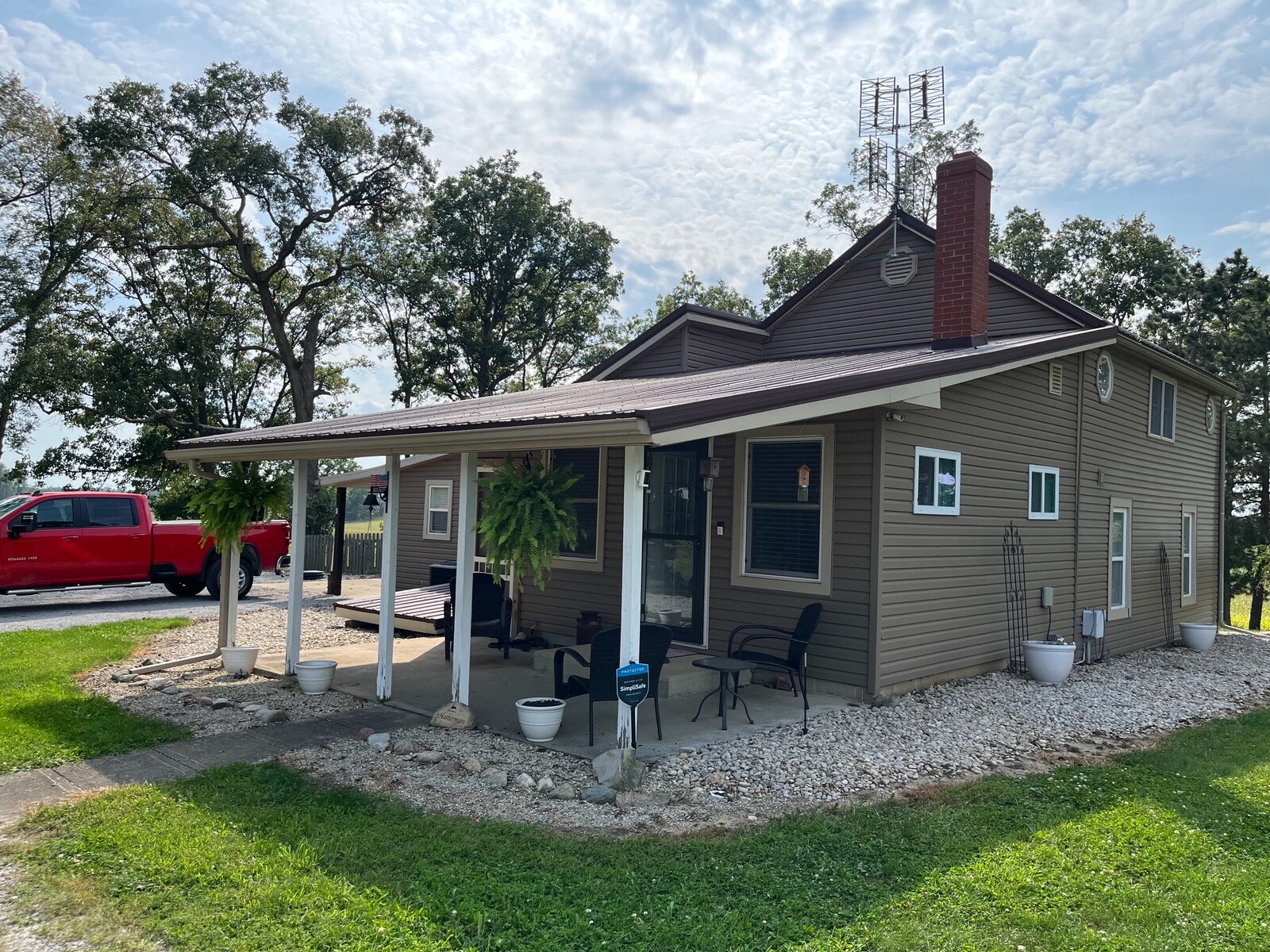 Completed metal roof installation shown from the front corner of a residential property.