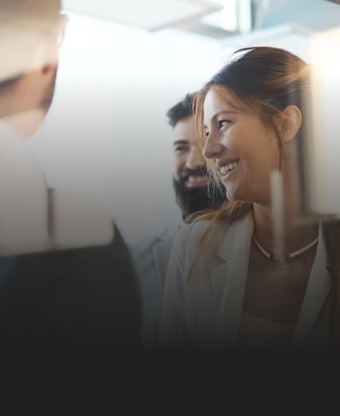 A close up short of smiling individuals at an event.