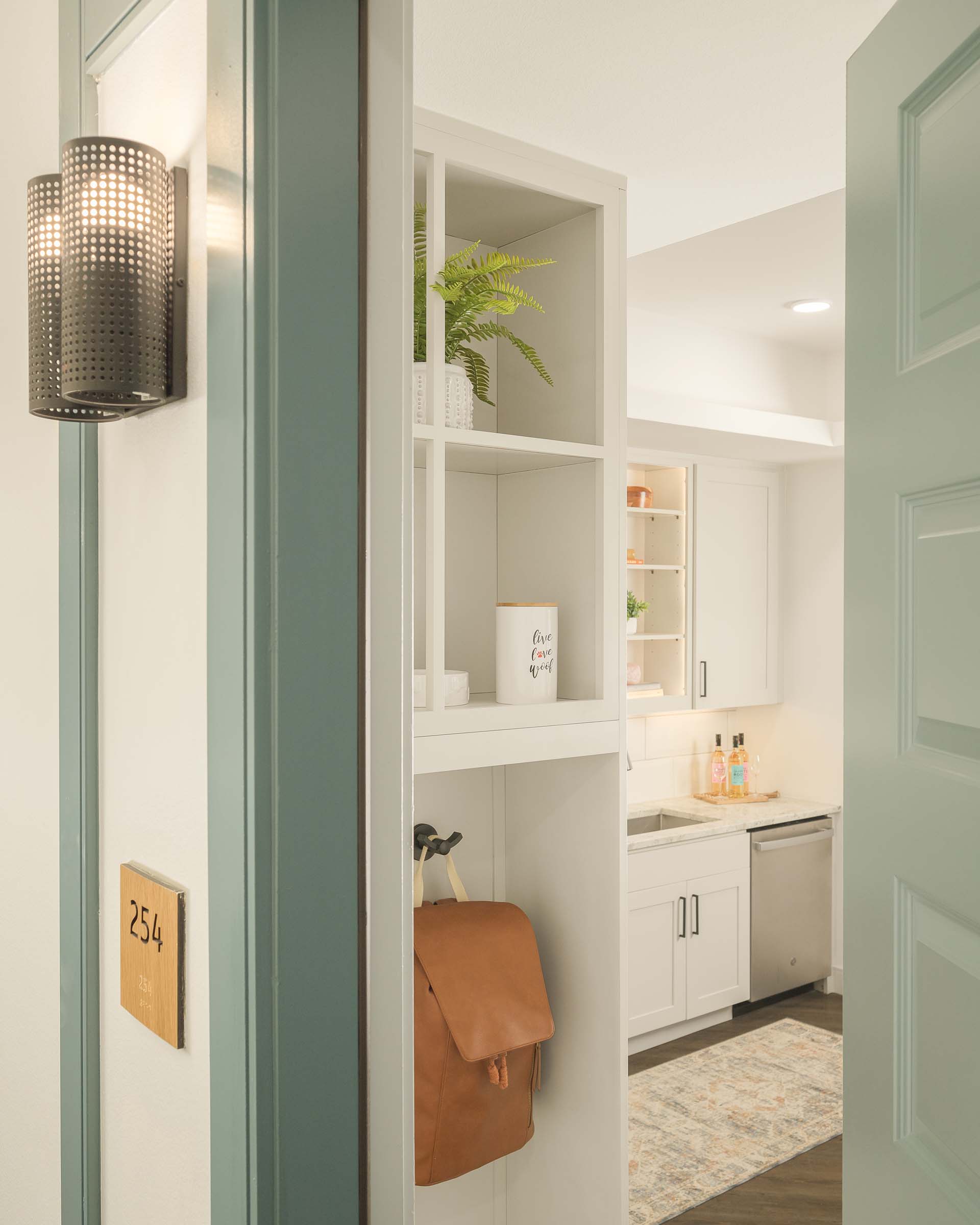 Front-door entry into drop zone with shelves and hooks at Camden Gilbert apartment homes in Gilbert, AZ