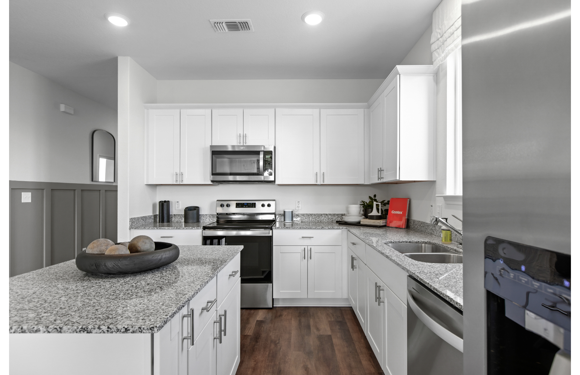 Open floor plan kitchen with cabinets and large island in new homes at Vista Real in Converse, TX