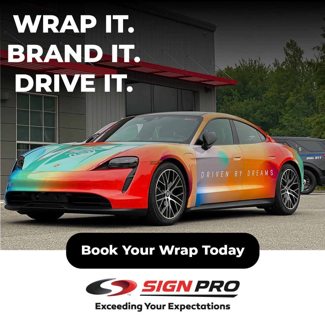 A custom-wrapped Porsche Taycan parked outside Sign Pro, Inc. demonstrates the power of vehicle wraps for bold branding and mobile advertising. The design reads “Driven by Dreams” and showcases vibrant, full-body graphics.