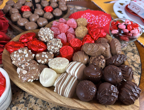 An artfully arranged platter featuring Florence's exquisite chocolates and confections. Located in Rexburg, Idaho, Florence’s Chocolates offers a premium selection of handcrafted sweets, including decadent truffles, chocolate-dipped delights, and heart-shaped treats. Perfect for gifting or indulging during special