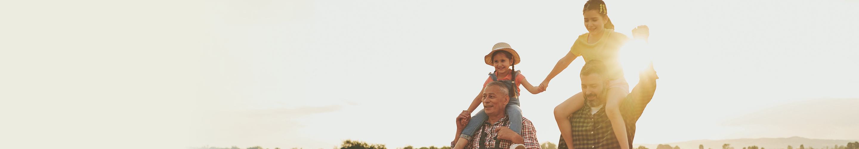A father and son with their kids and grandkids on their shoulders.
