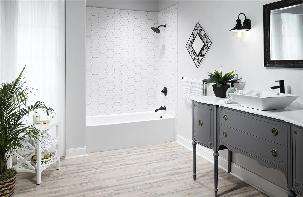 Bathroom remodel by Luxury Bath featuring a bathtub and shower area with wall surround panels, updat 