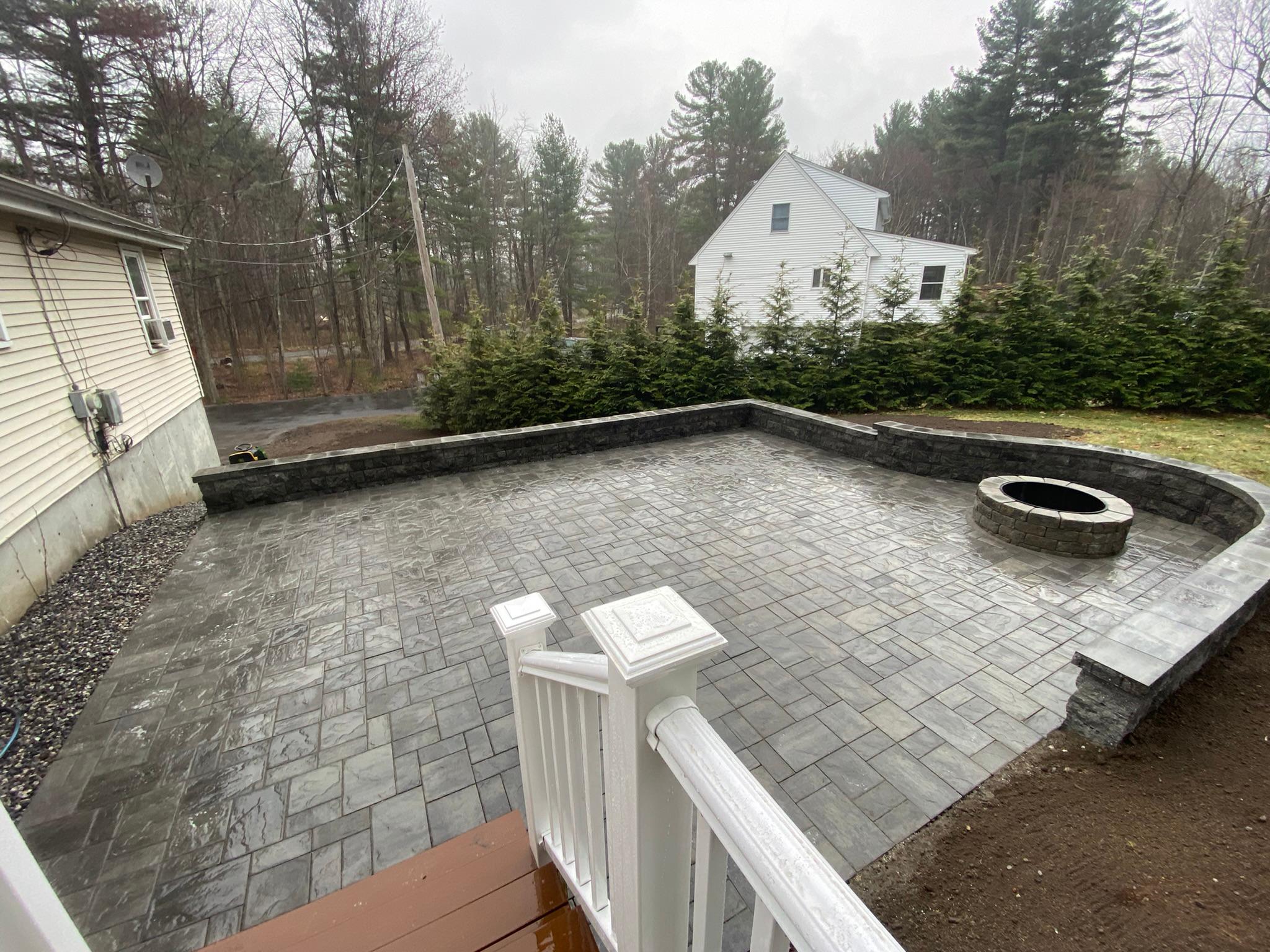 Patio with fire pit and retaining wall.