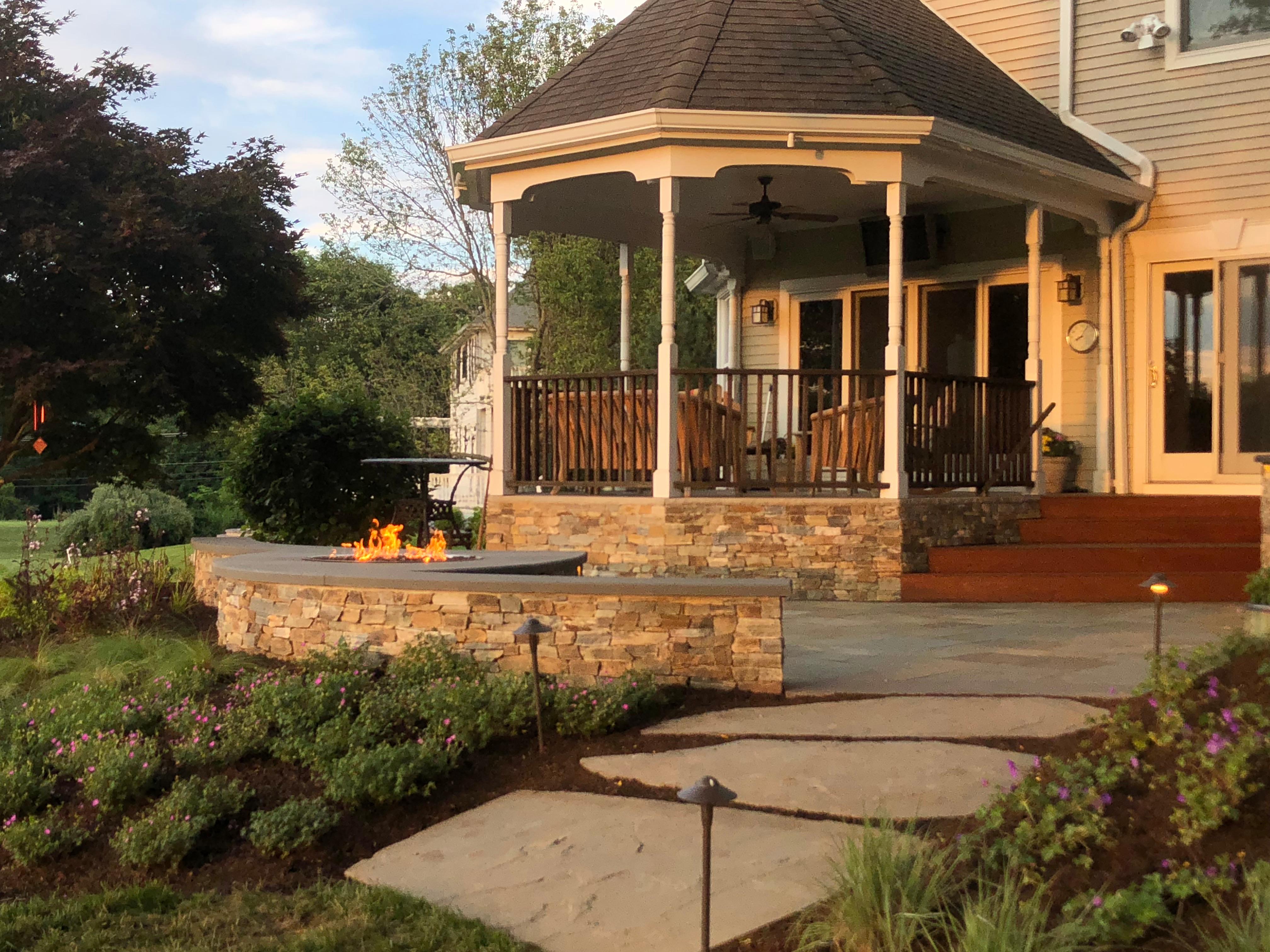 We completed this front porch last year which was the final phase of a multi-year master plan design build project.  Our clients appreciation for the outdoors and what we have created for him and his family is expressed in his smile!  On a couple occasions we have had the opportunity to enjoy the bar and fire feature with our client!  www.gardenartisansllc.com