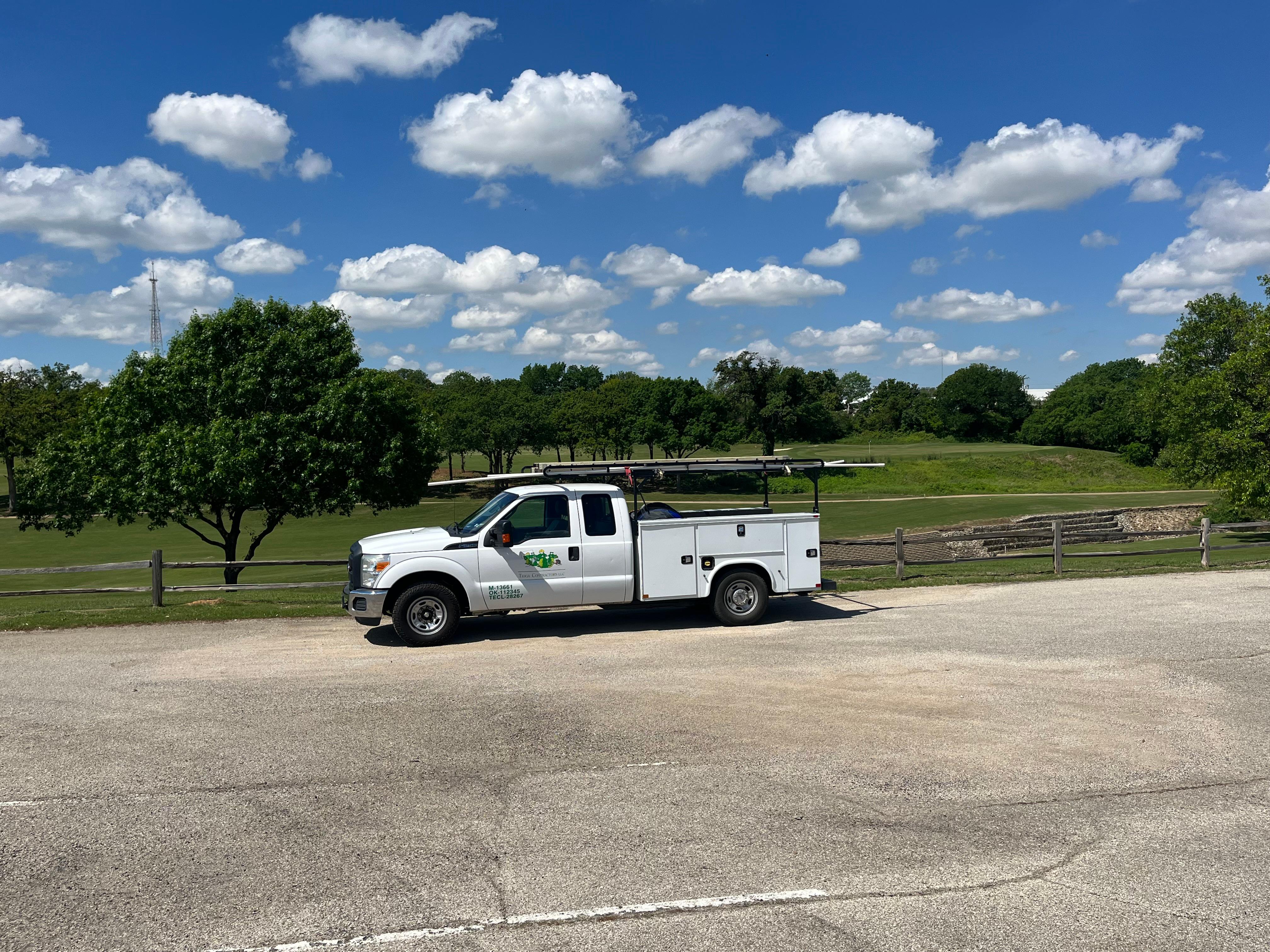 A Tioga Plumbing & Electric truck near Euless Texas at a golf course.