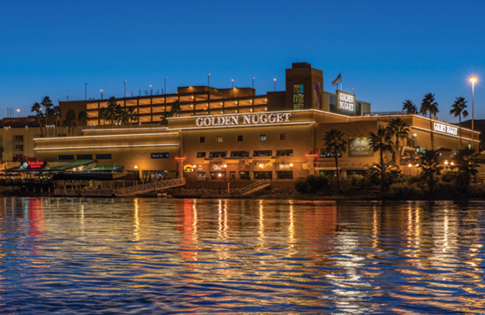 Golden Nugget Laughlin hotel illuminated at night along the river