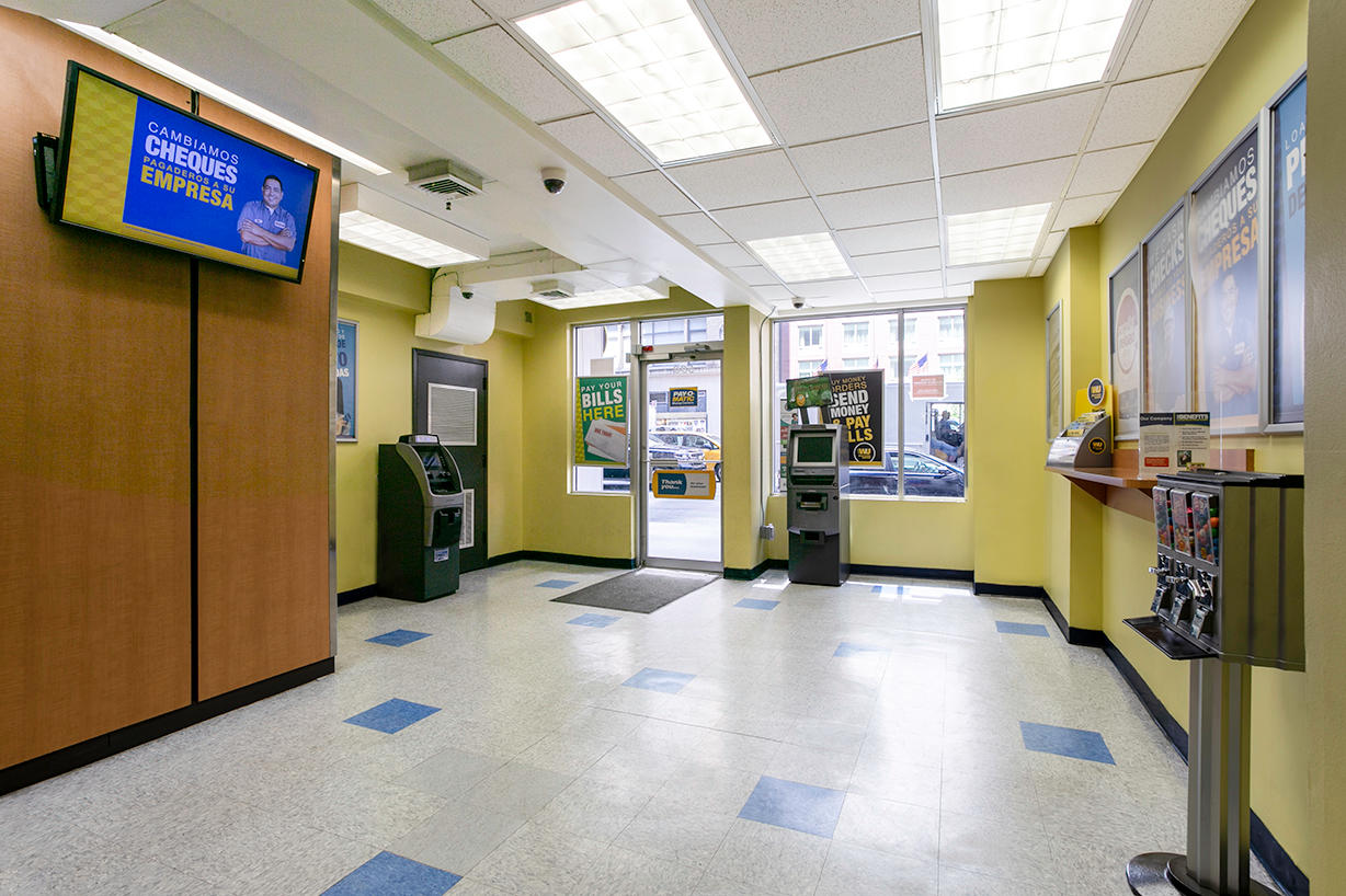 Customer waiting area and entrance inside PAYOMATIC store located at 590 Eight Ave New York, NY 10018