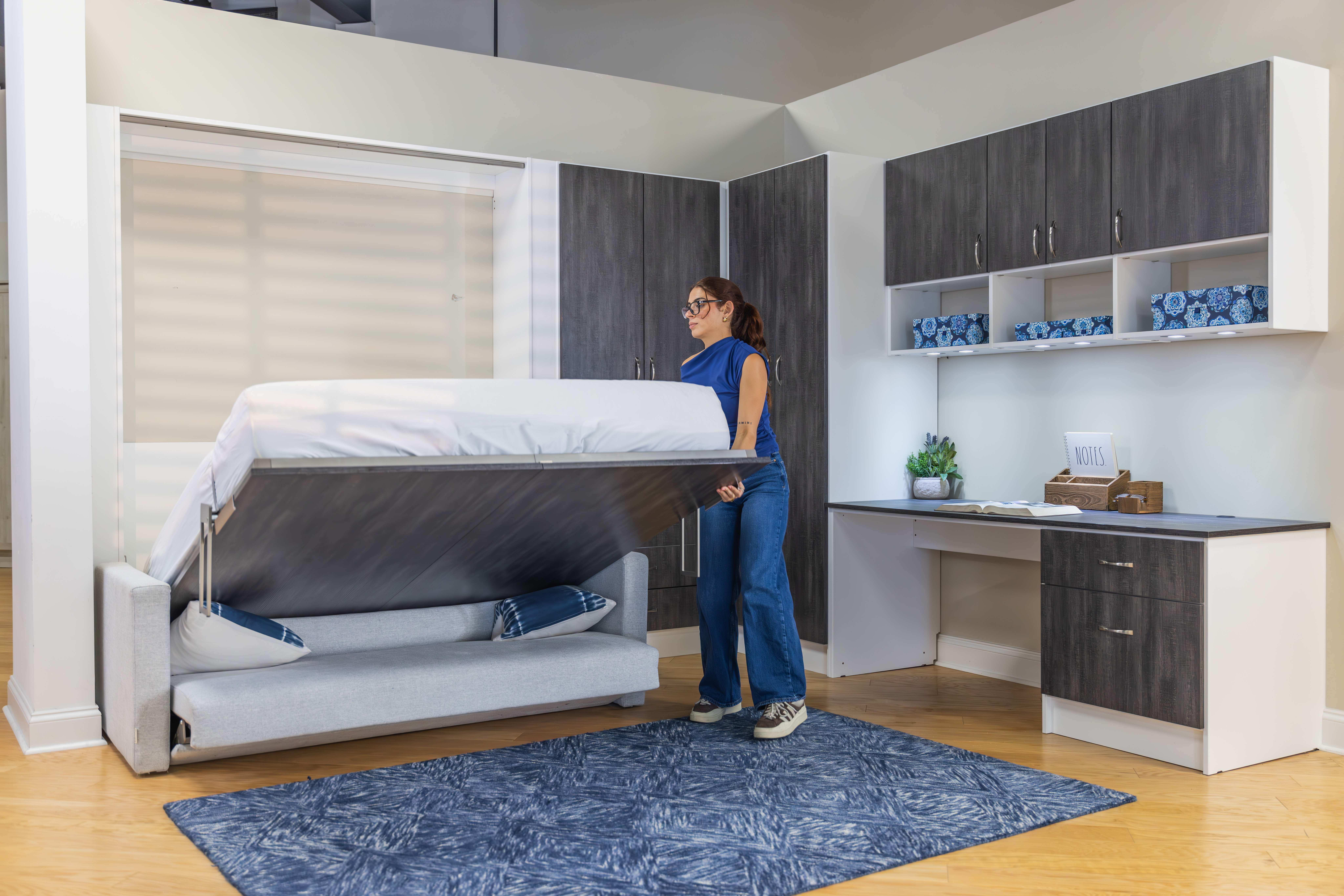 Woman unfolding a murphy bed