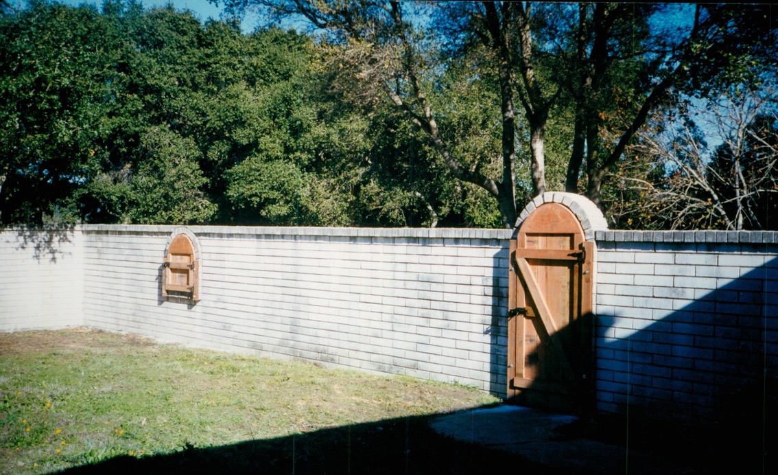 White privacy fence surrounding a residential yard for security, separation, and clean curb appeal.