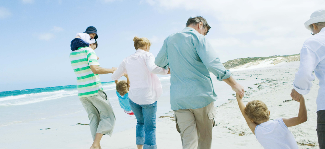 A family strolling on the beach.