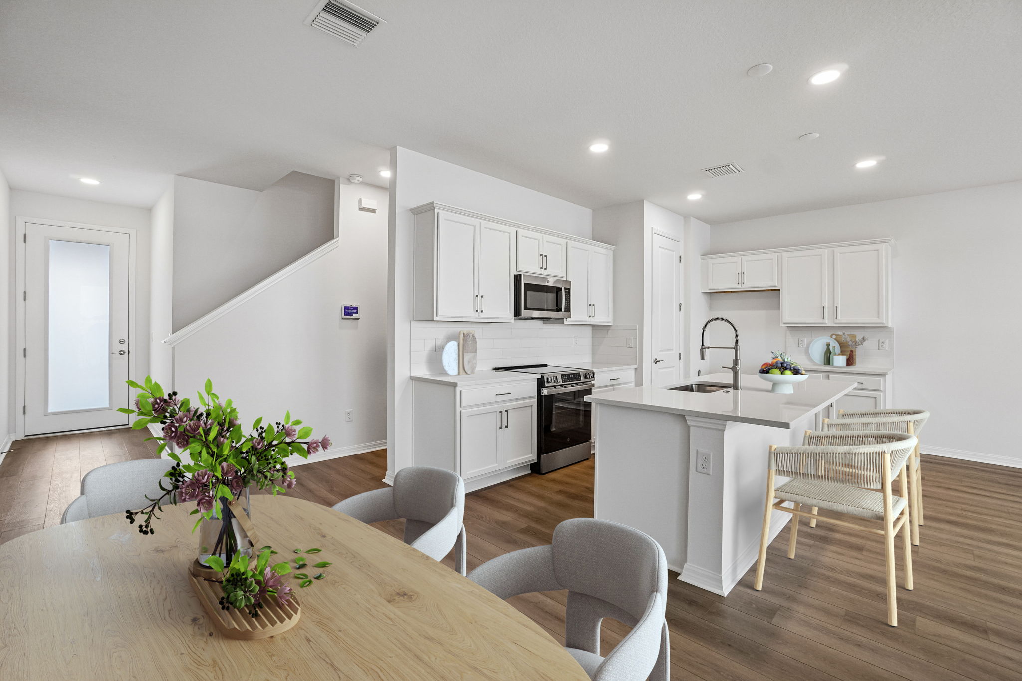 The Dining Room and Kitchen of a DRB Homes Aruba Quick Move-In Homes at Isla Mirada in San Antonio,  