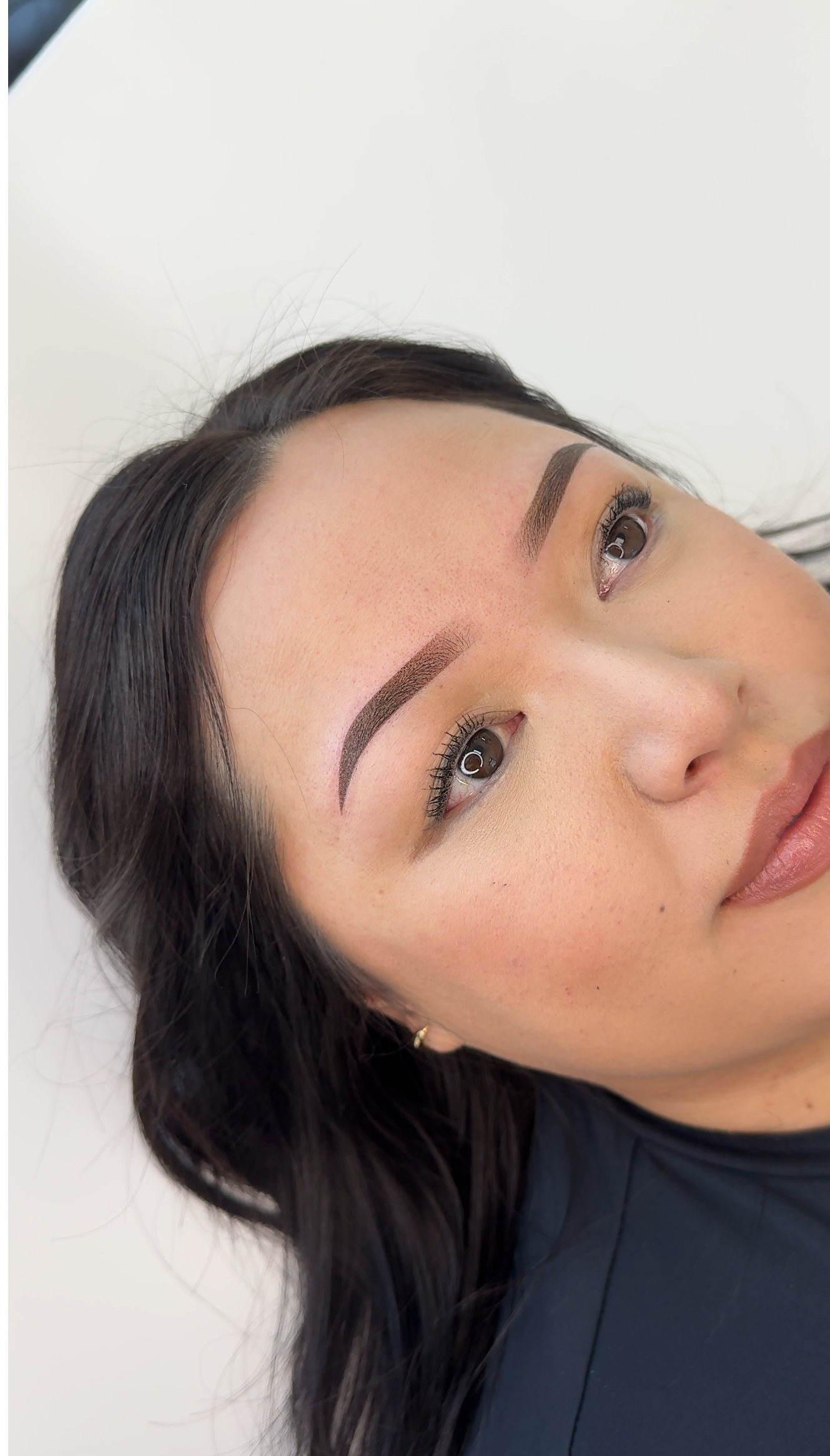 Close-up photo of a client&rsquo;s ombr&eacute; powder brows, created by an Asian-owned PMU trainer in Utah, showing a smooth shaded effect.