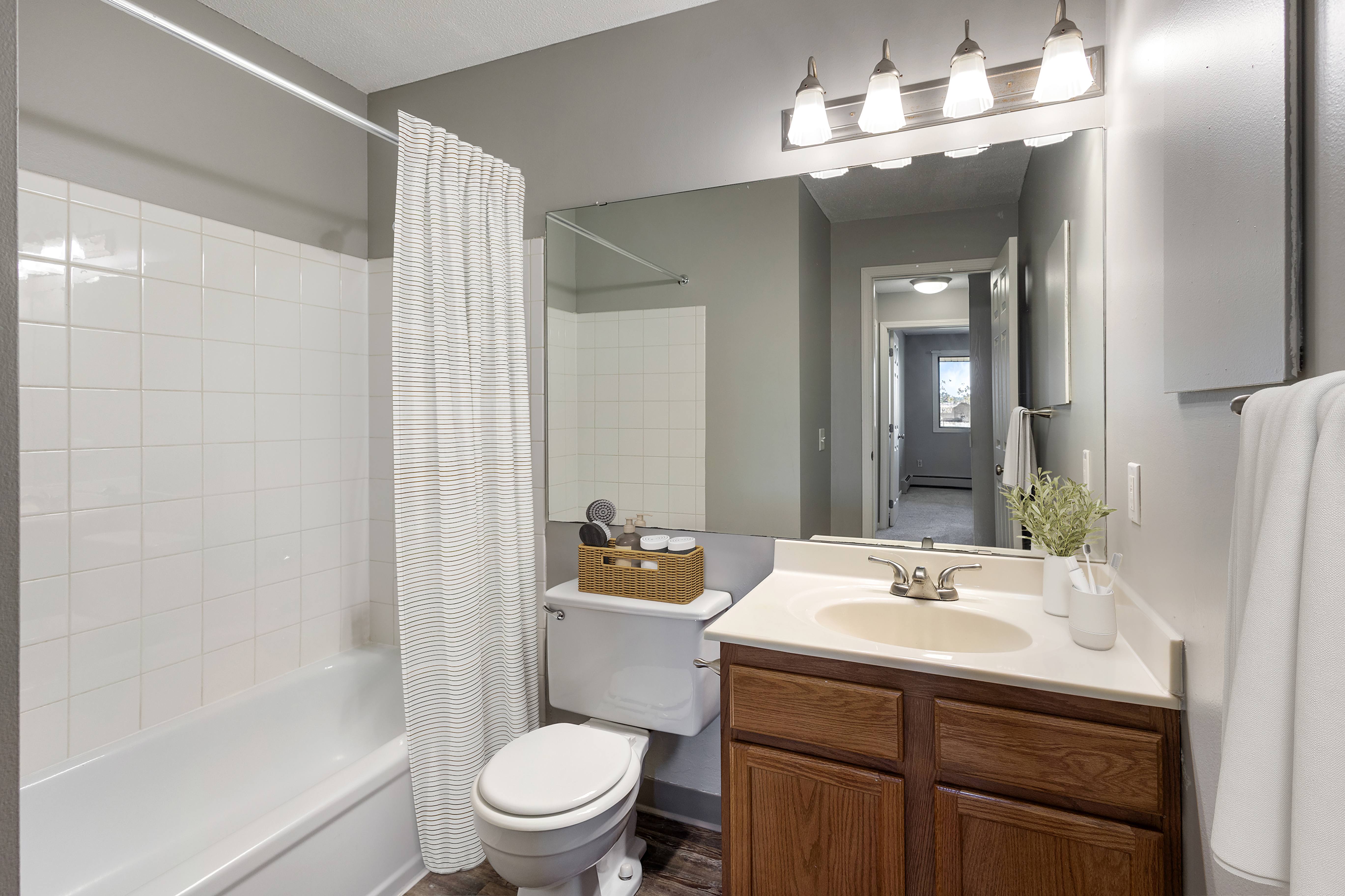 A bathroom with a white toilet, a white sink, and a white bathtub