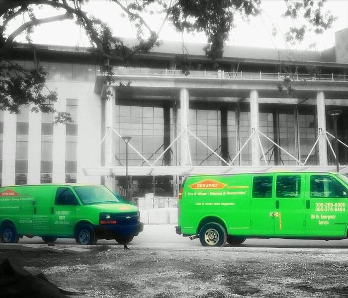 Pictured are two Green Vans, just a small part of the fleet of SERVPRO of South Miami. The large commercial building in the background is being serviced by our highly qualified personnel. We can provide scheduled cleaning floor by floor or door by door; we have no limitations. We are skilled at commercial building services after an emergency fire, water, or mold damaging event.