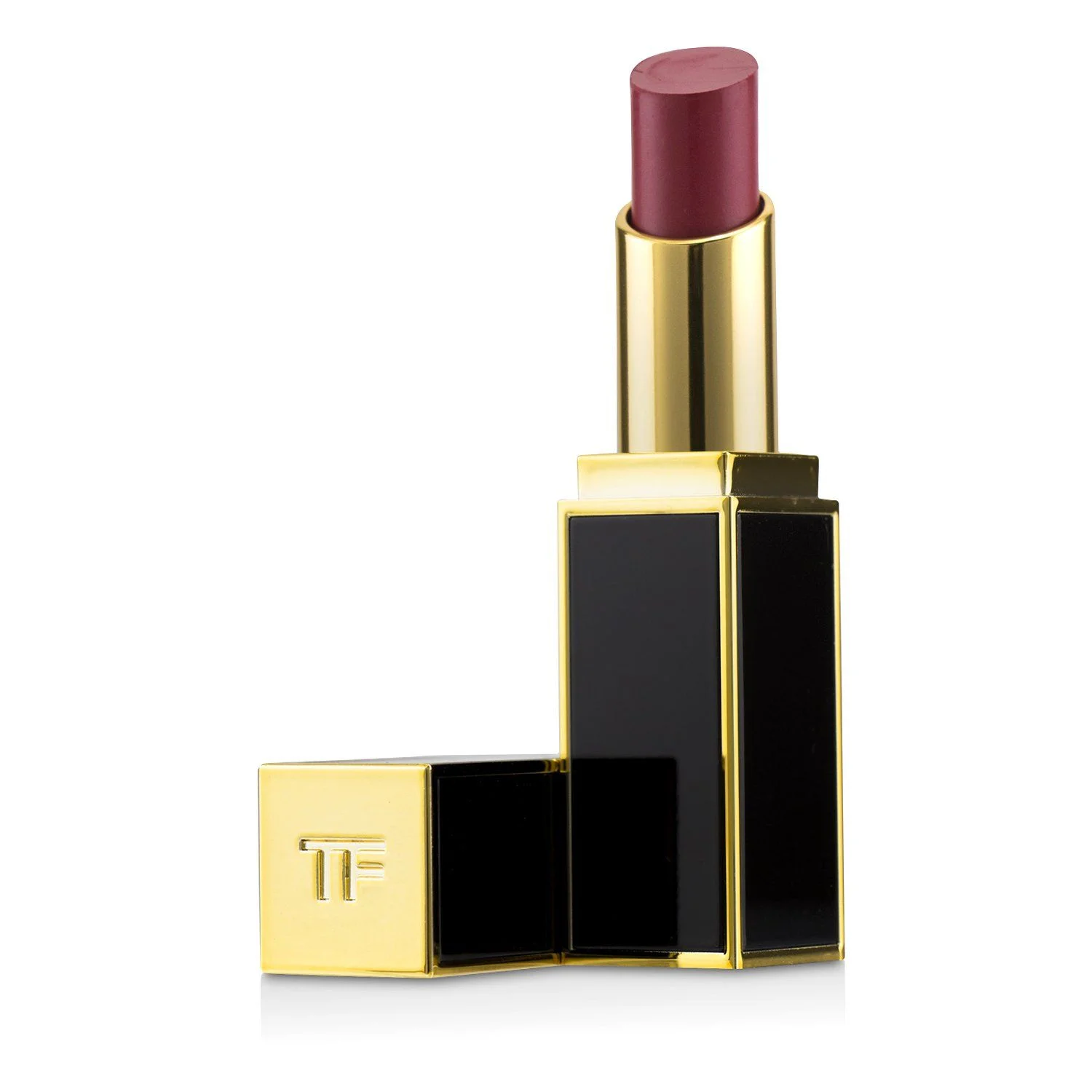 A close-up studio shot of a Tom Ford lipstick in a deep berry shade, with the gold and black packaging open. The lipstick bullet is angled upwards and to the left, revealing the rich color. The cap, also gold and black, rests to the left of the base, with the "TF" logo embossed on its top surface.