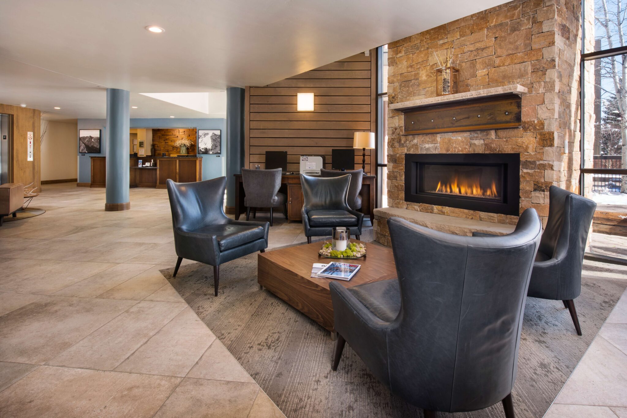 The lobby at Vail Spa Condominiums, featuring comfortable seating around a fireplace 