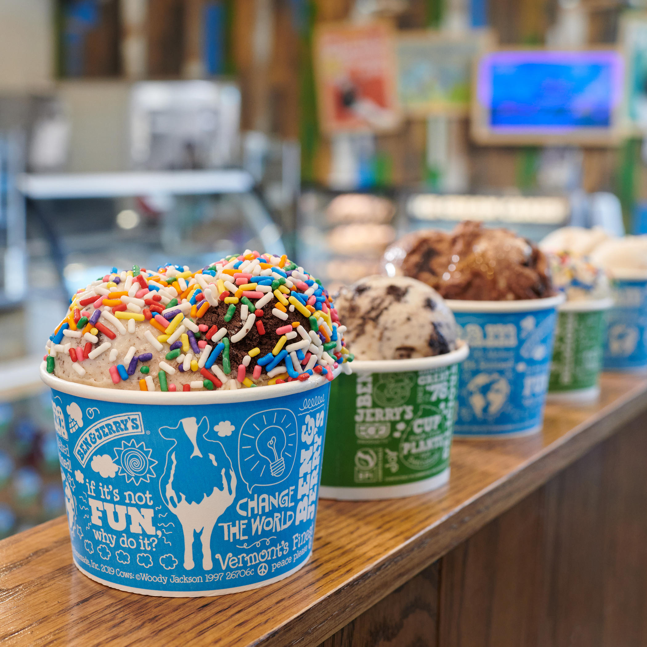 Multiple ice cream cups on a railing in a Ben & Jerry's ice cream shop. Ben & Jerry's Broadbeach (07) 5538 5708