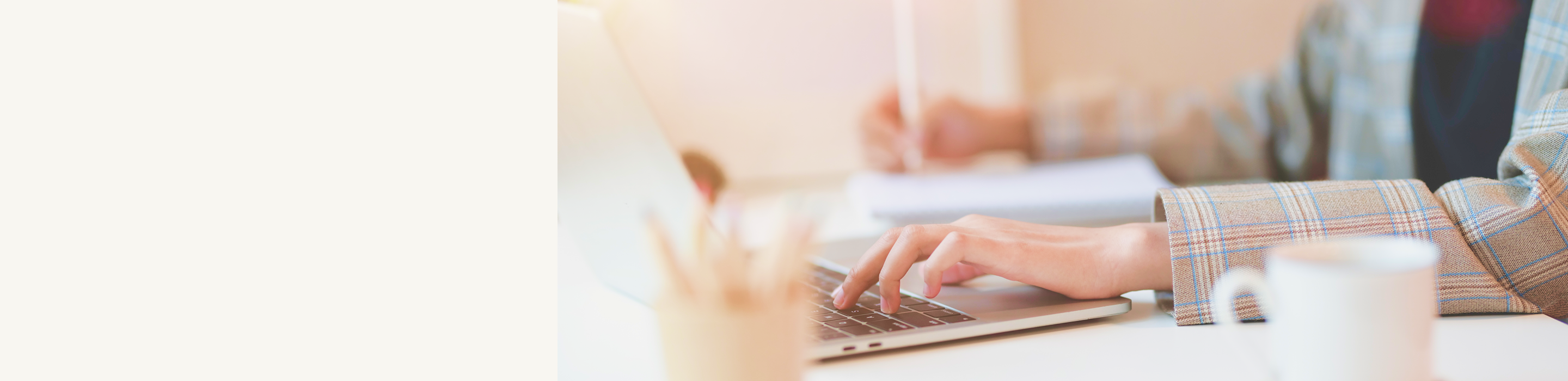 Hands typing on a laptop.