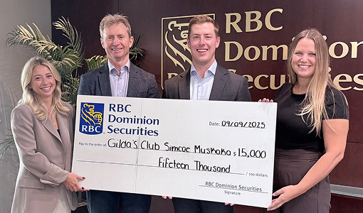 Members of The Madison Group presenting a giant cheque to Gilda's Club Simcoe Muskoka.