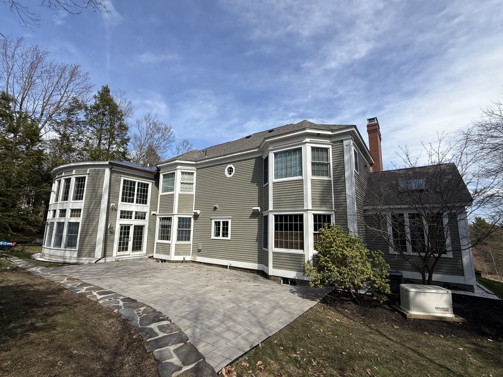 Completed residential exterior renovation featuring siding installation, architectural detailing, and custom construction work completed by M & Son Construction.