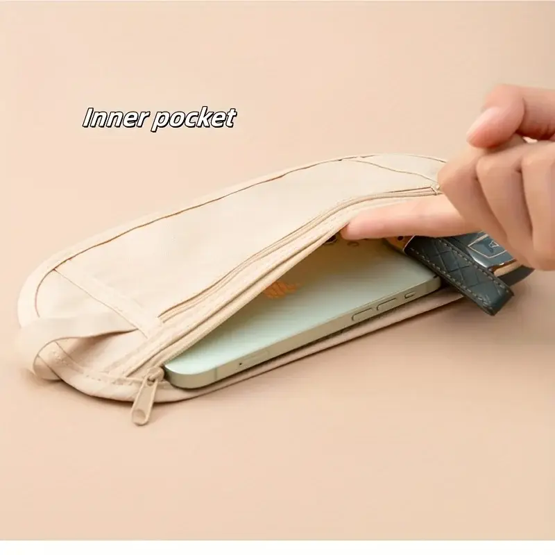 A hand is shown placing a smartphone into a zippered pocket of a light beige fabric pouch, likely a travel wallet or organizer. A key fob with a dark green strap is also visible near the phone's insertion point, suggesting the pouch is designed to hold essential items for travel or daily use.