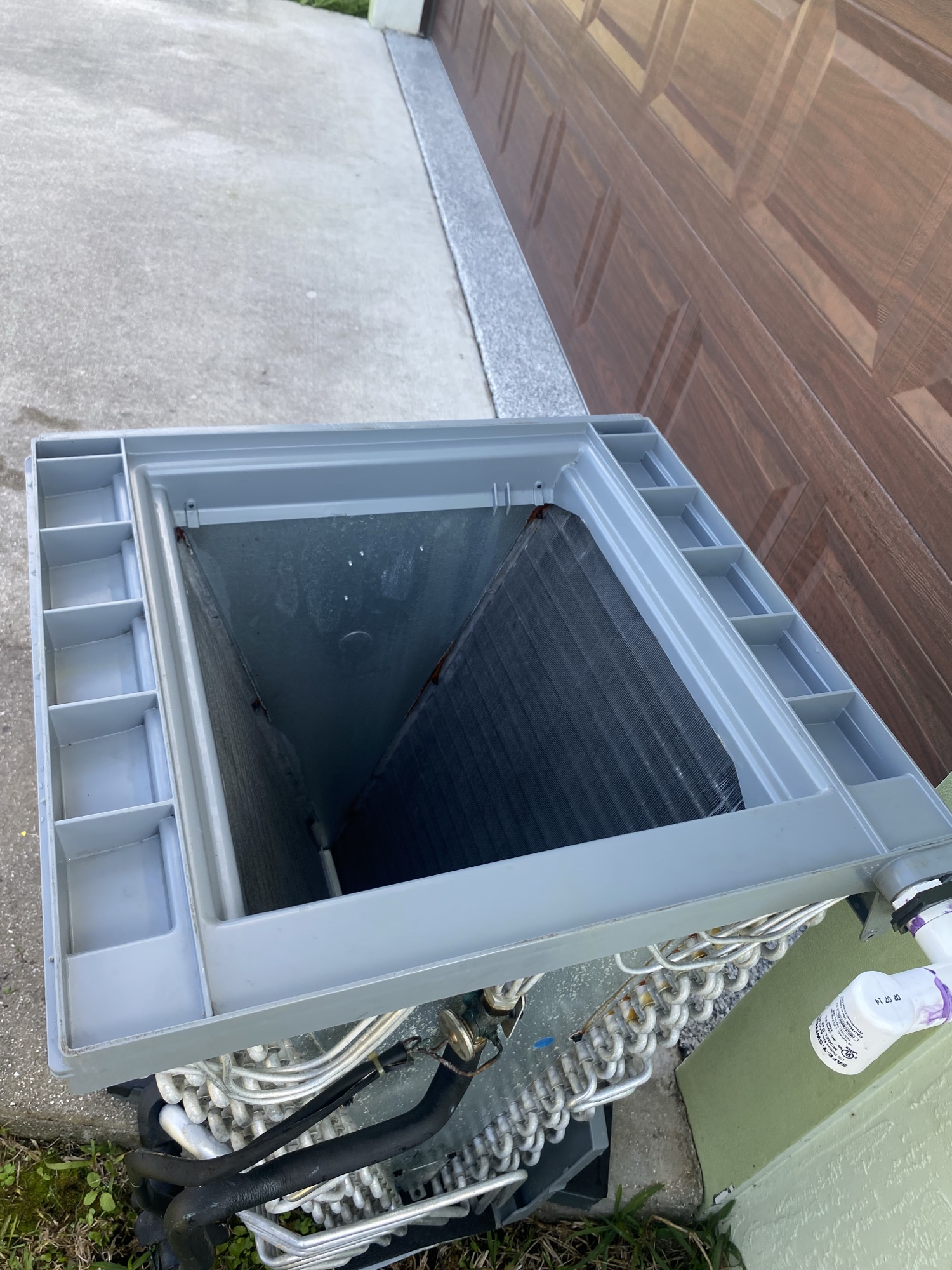 AC condenser coil maintenance for a residential cooling system by Tri-County HVAC in Palm Beach County.