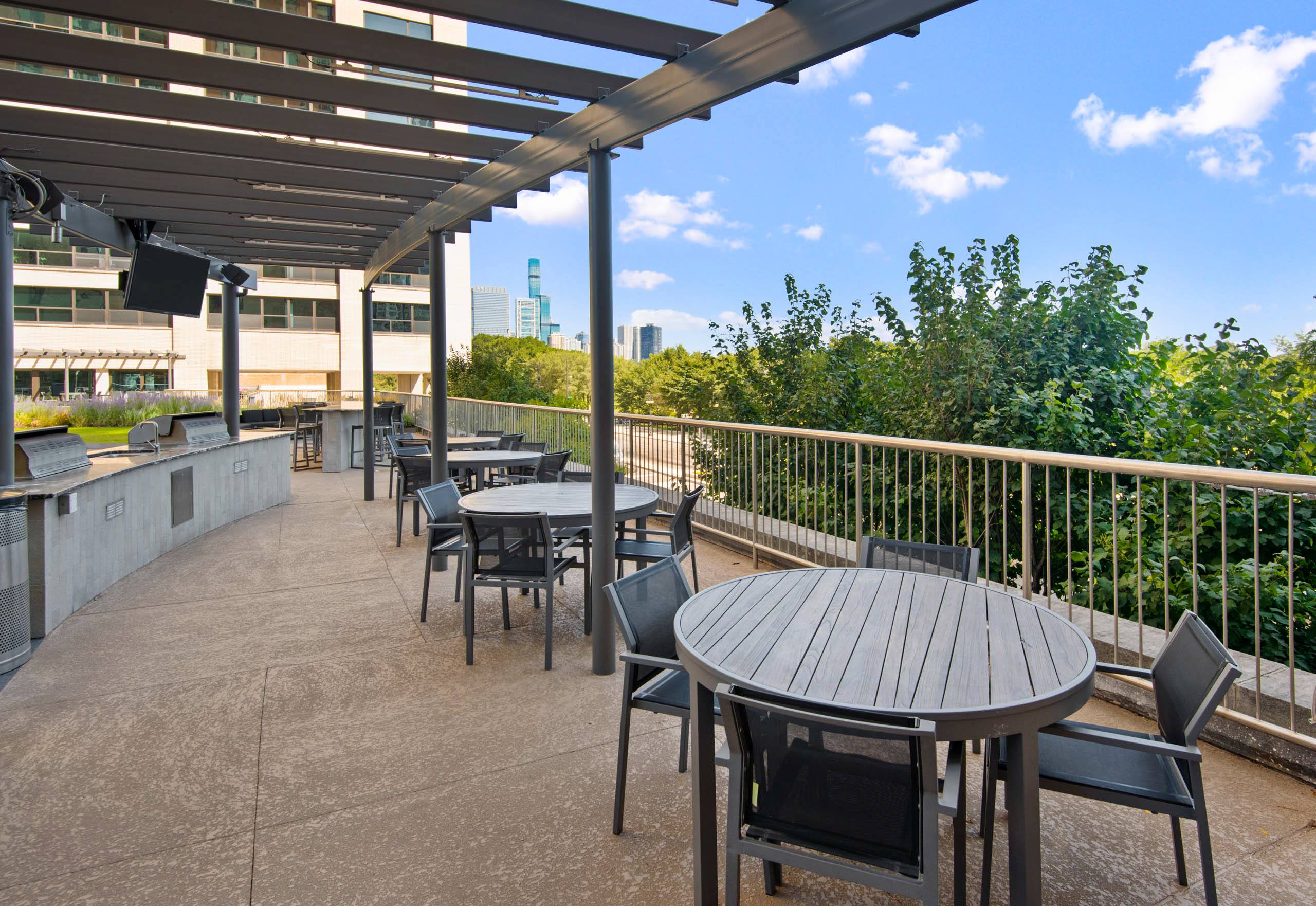 Rooftop dining terrace with outdoor kitchen and city views 