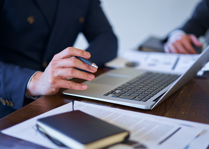 A person typing on a laptop computer.