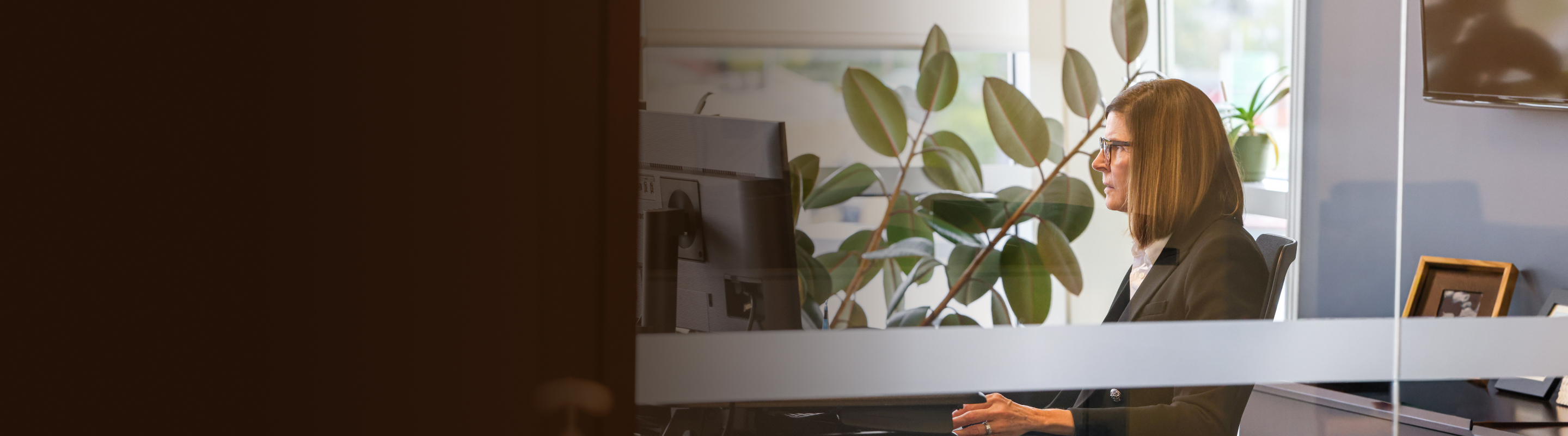 Kathy Dion engaged in focused work in her office.