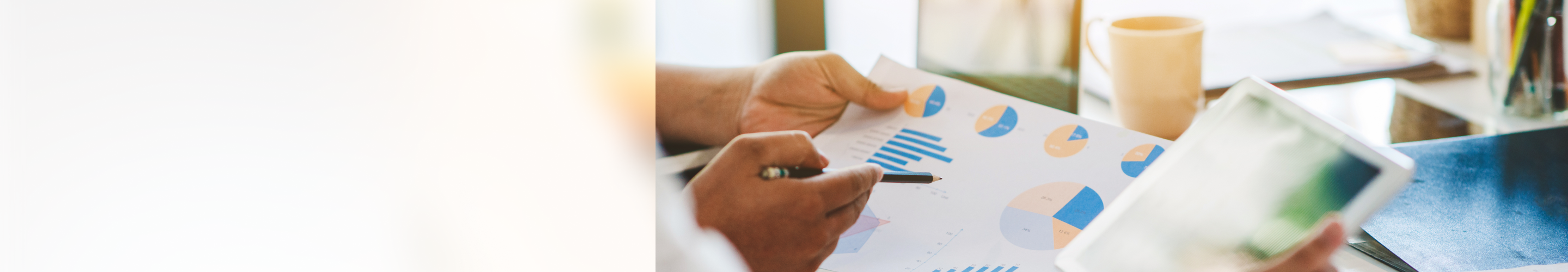 Close-up of two people reviewing charts and graphs.