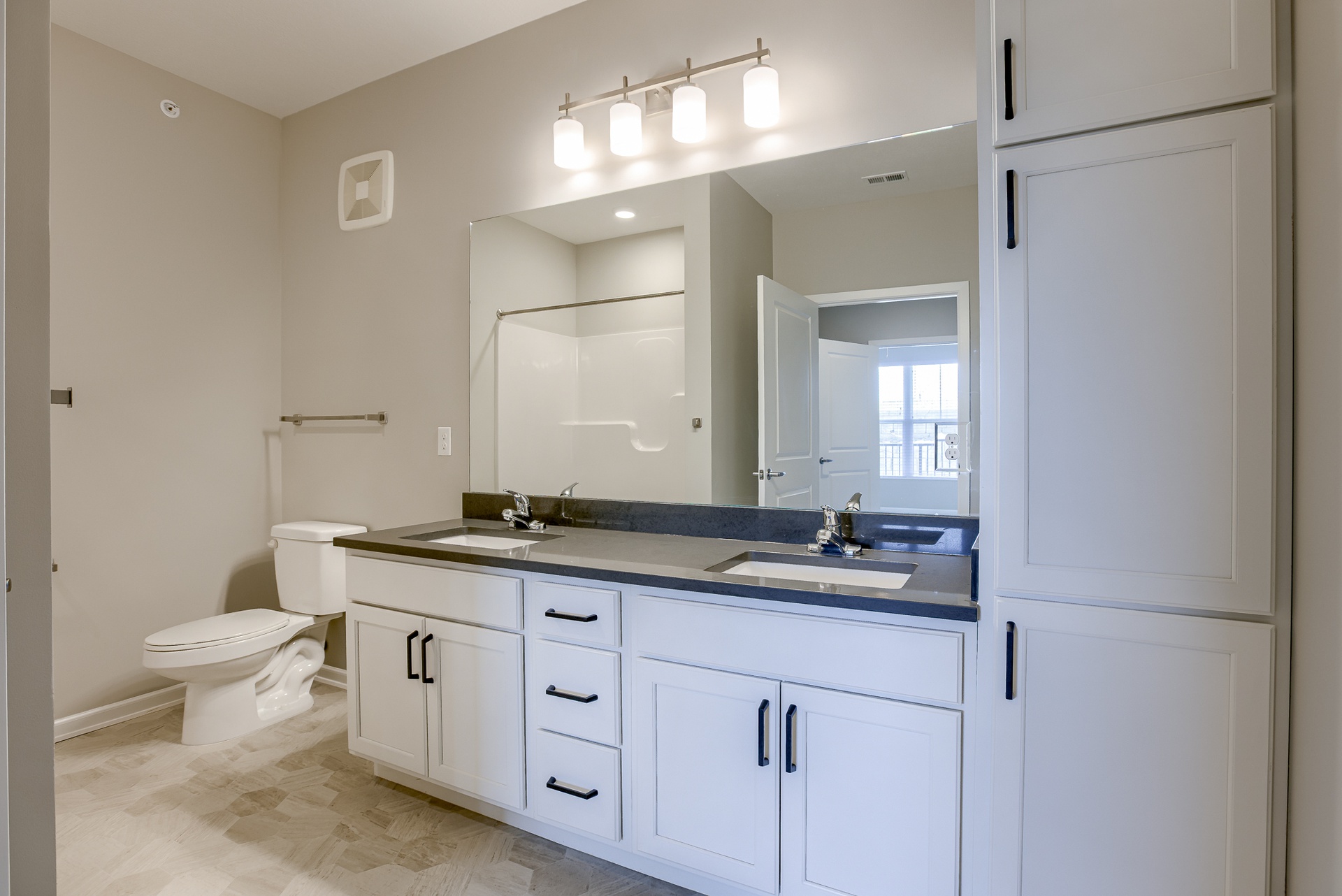 Bathroom with Dual Vanity and White Cabinetry