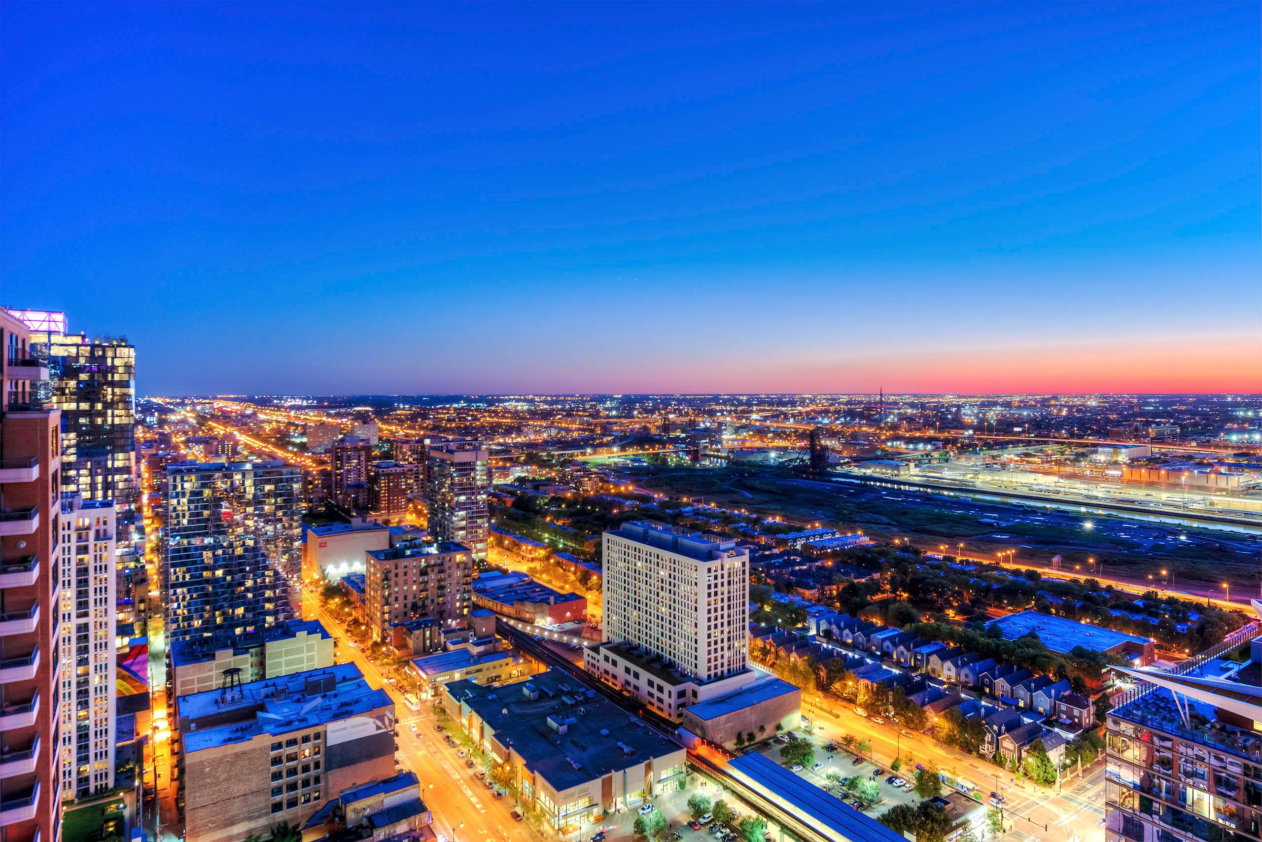 Aerial twilight view of illuminated city skyline 