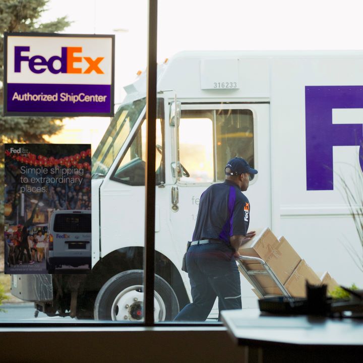 A window with FedEx Authorized ShipCenter sign and FedEx truck and courier in background FedEx Authorized ShipCenter Fort Walton Beach (251)753-8221