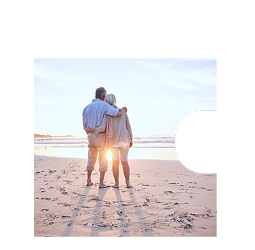 A couple embracing on the beach at sunset.