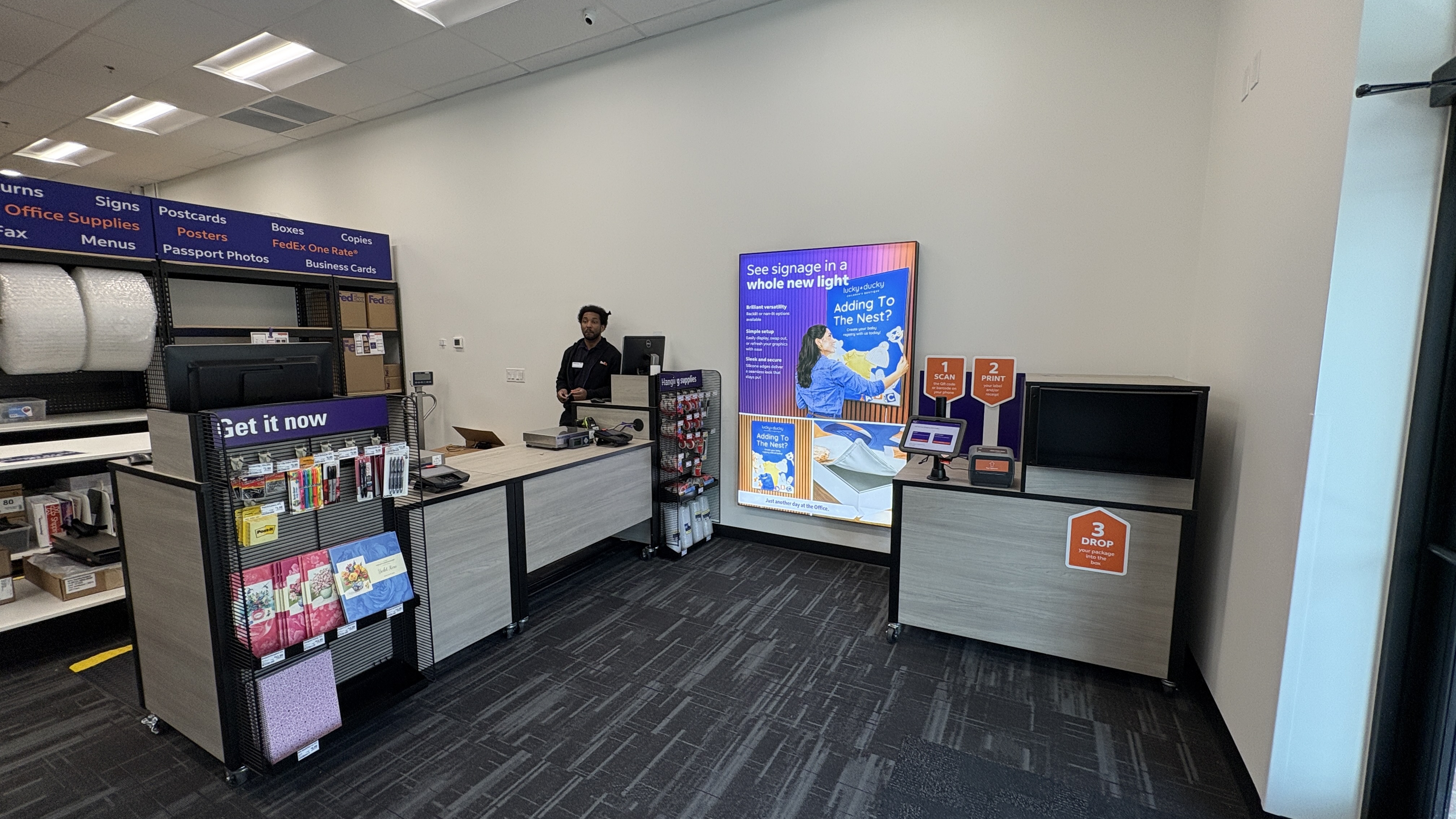 The service counter and package drop-off station at the FedEx Office in Atlanta, where team members can assist with shipping needs.