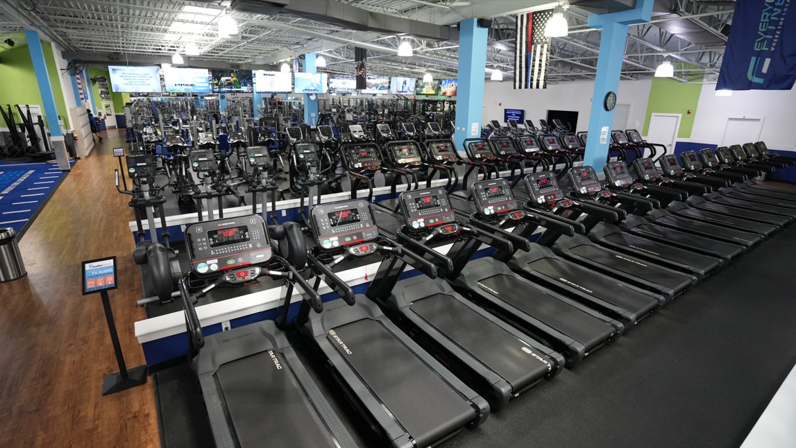 Full cardio training area at Everyone Fitness Rehoboth Beach showcasing modern treadmills, bikes, and rowers.