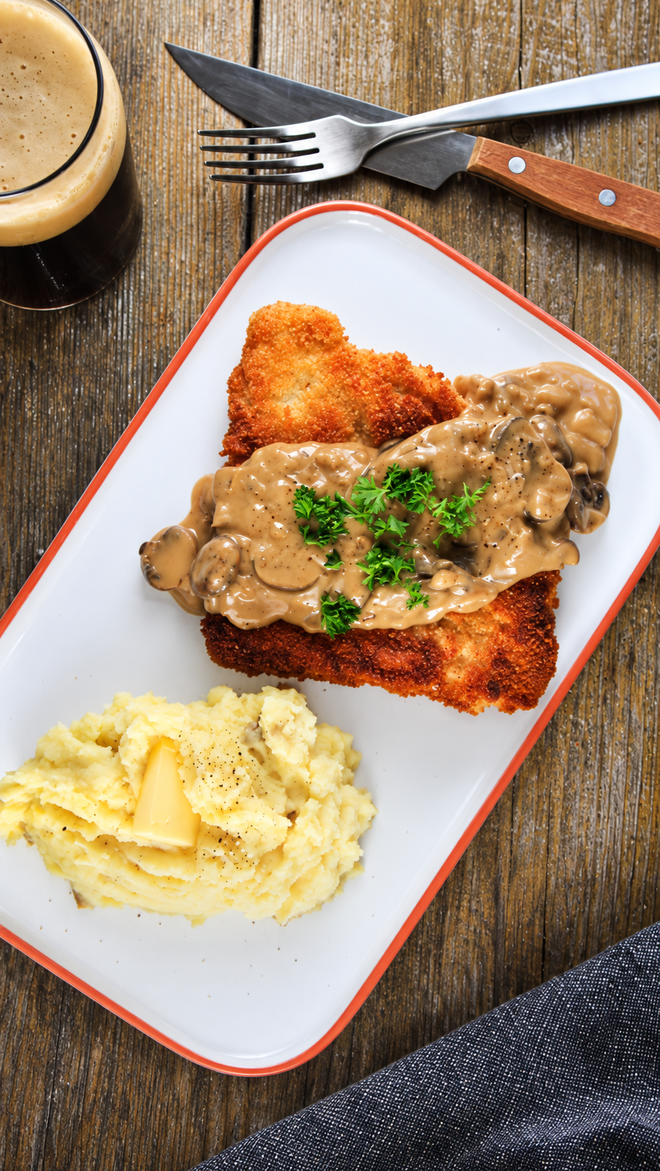 Enjoy a cozy meal from Chef Darin’s Kitchen Table: tender pork schnitzel, breaded and fried to golden perfection, topped with rich creamy mushroom gravy and served with buttery mashed potatoes. Prost!
