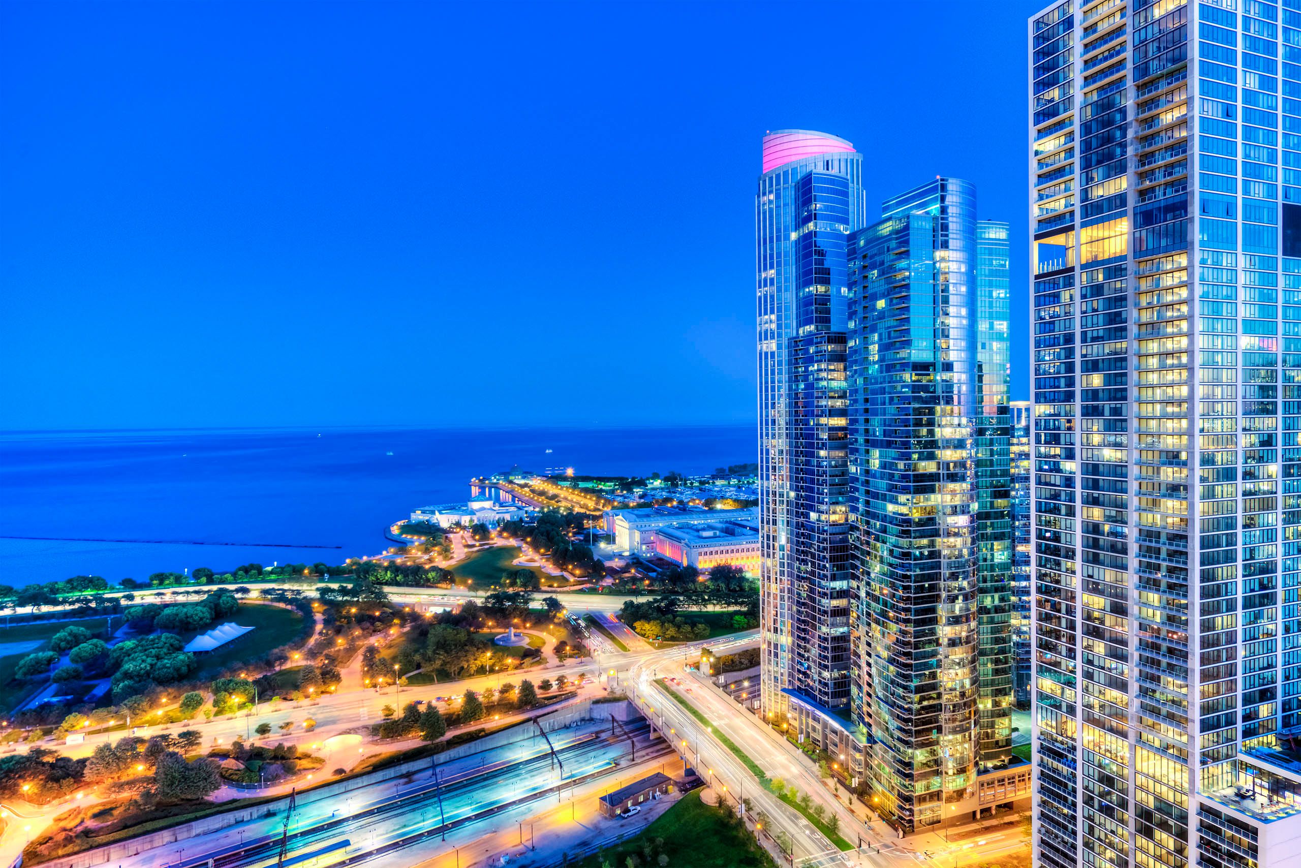 Twilight view of waterfront park and modern towers 