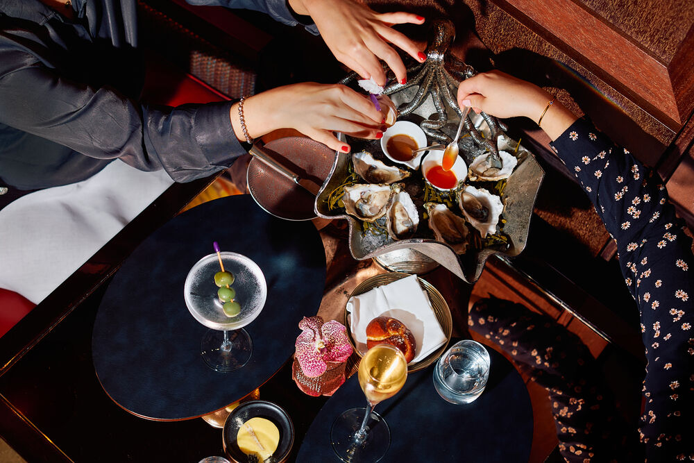 Lifestyle shot of guests enjoying oyster at Bar45