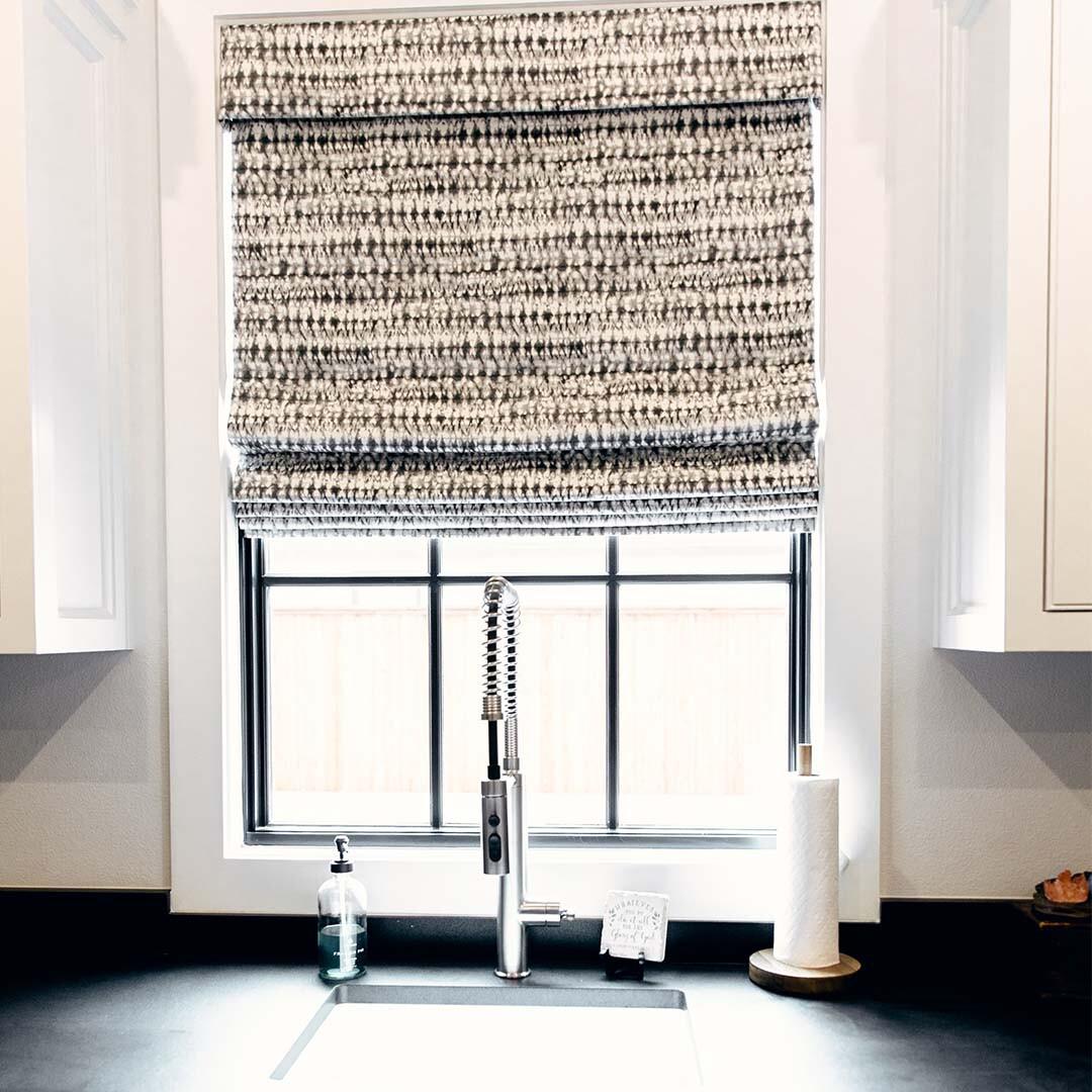 Add texture and style to any space with highly versatile Roman shades. This shade brings a thick, soft pattern that brings warmth and comfort to this kitchen. With a wide range of fabrics, colors and patterns to choose from, there's no limit to what you can design.